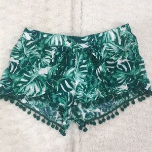 Green floral shorts.